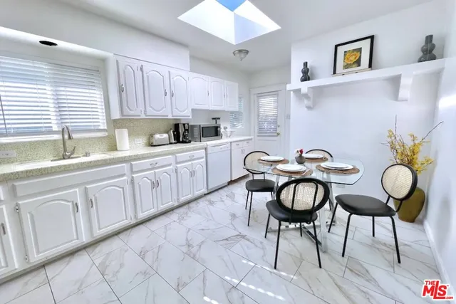 a kitchen with cabinets and chairs