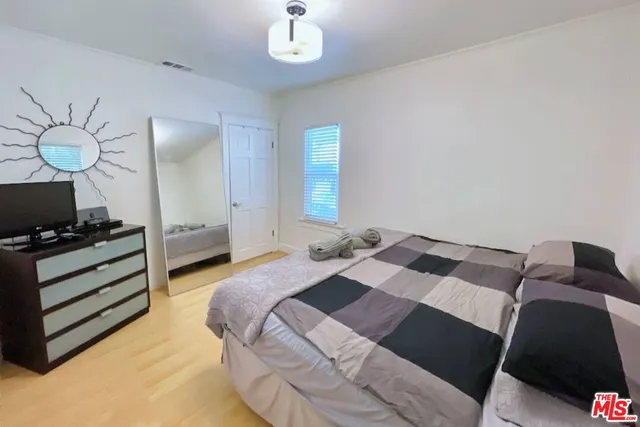 a bedroom with a bed and a television