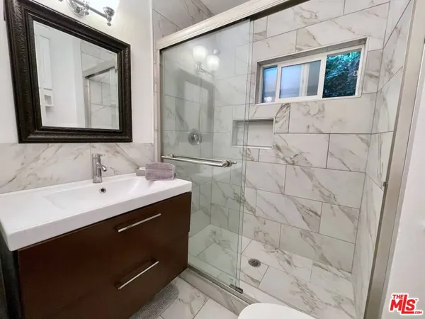 a bathroom with a sink vanity granite and a mirror