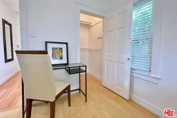 a view of a dining room with furniture and a window