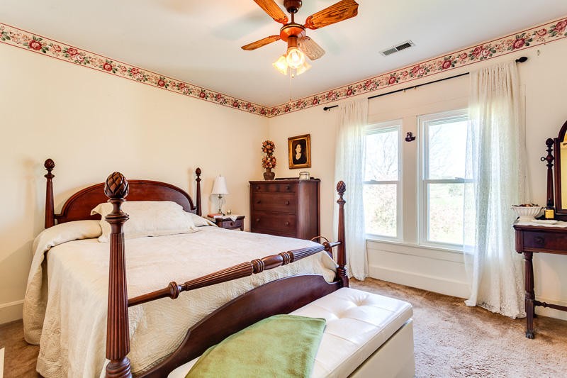 4307 McGinnis Road Corryton, TN 37721 - Photo 14 of 39 a bedroom with a bed and a chandelier