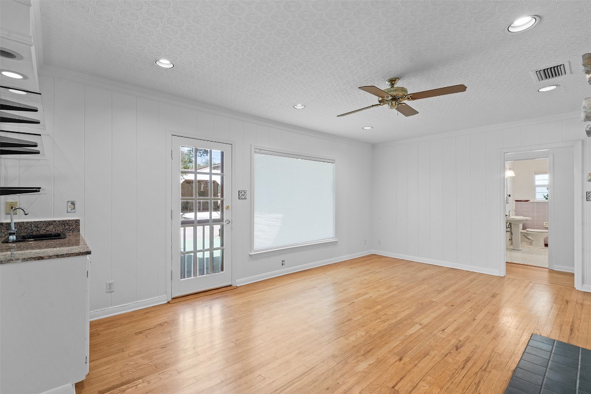 2606 Westover Road Austin, TX 78703 - Photo 13 of 38 a view of empty room with wooden floor and fan