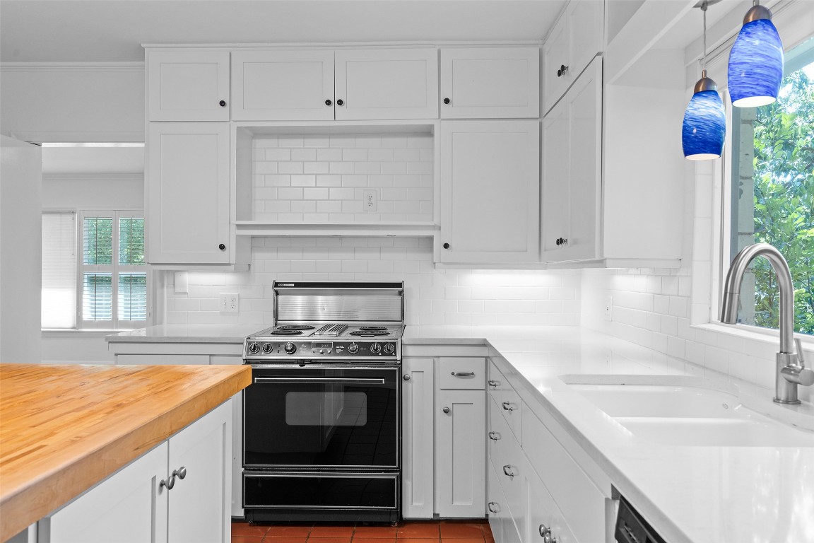 2606 Westover Road Austin, TX 78703 - Photo 18 of 38 a kitchen with granite countertop a sink stainless steel appliances and cabinets