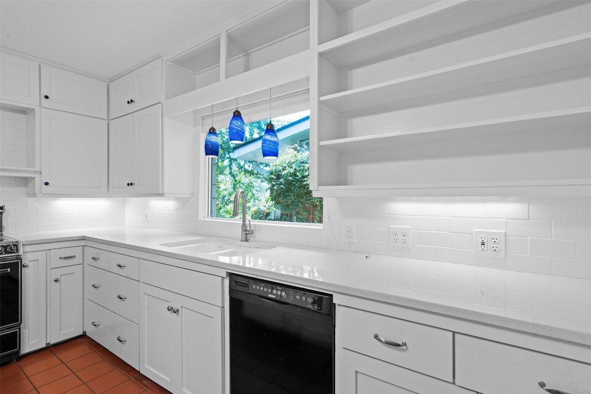 2606 Westover Road Austin, TX 78703 - Photo 20 of 38 a kitchen with stainless steel appliances white cabinets and a sink