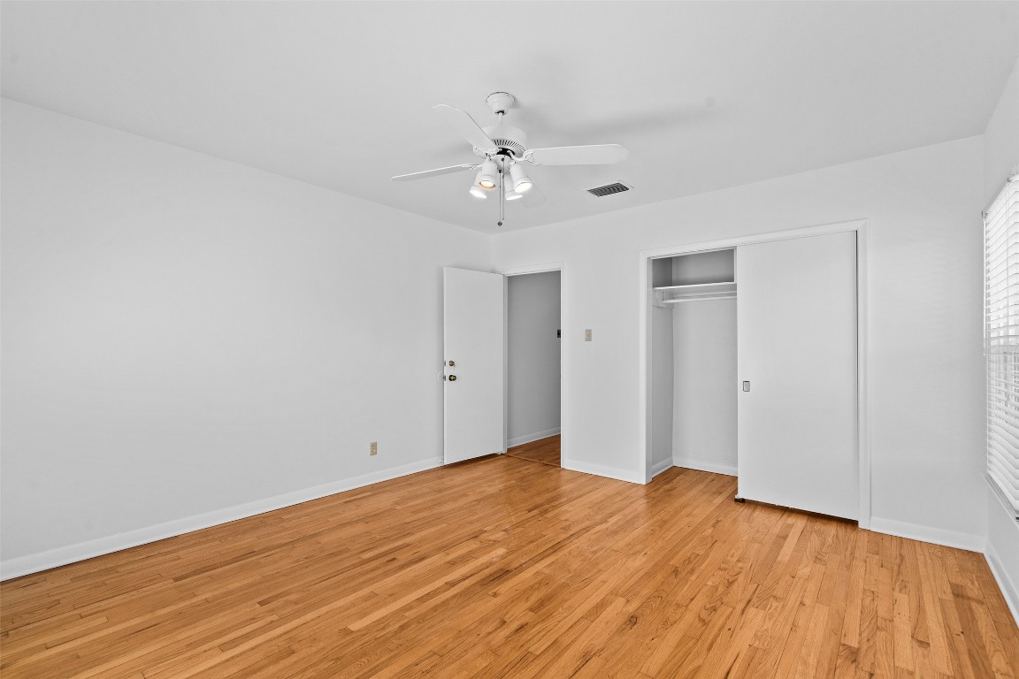 2606 Westover Road Austin, TX 78703 - Photo 21 of 38 a view of empty room with wooden floor and ceiling fan