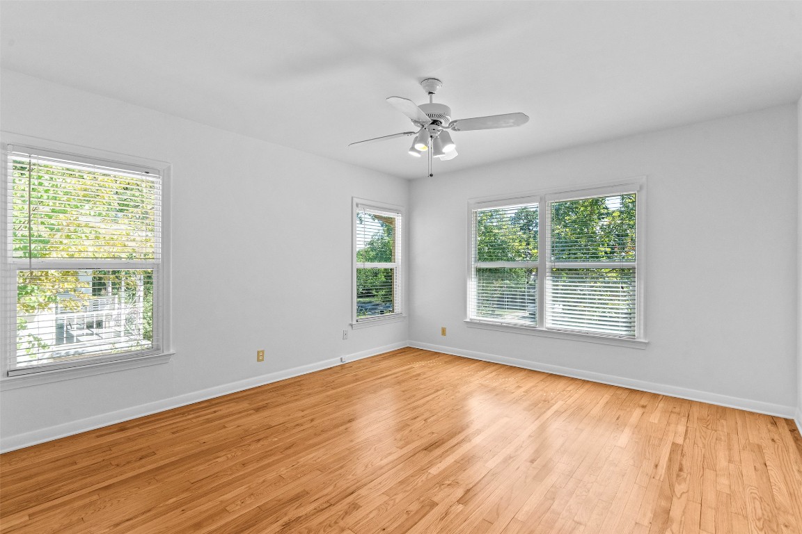 2606 Westover Road Austin, TX 78703 - Photo 22 of 38 a view of an empty room with wooden floor and a window