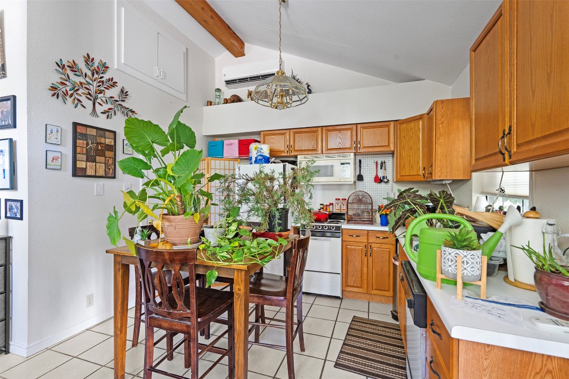 2606 Westover Road Austin, TX 78703 - Photo 25 of 38 a view of a dining room with furniture a potted plant and a kitchen view