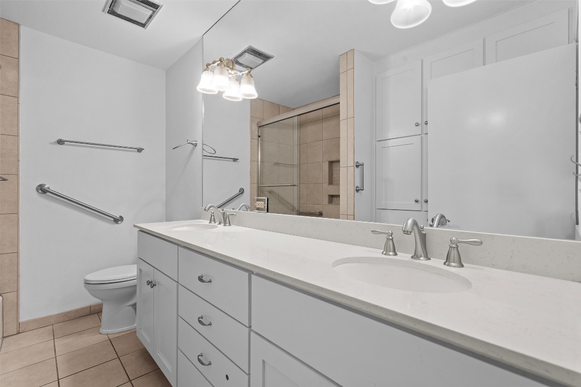 2606 Westover Road Austin, TX 78703 - Photo 28 of 38 a bathroom with a double vanity sink mirror and toilet