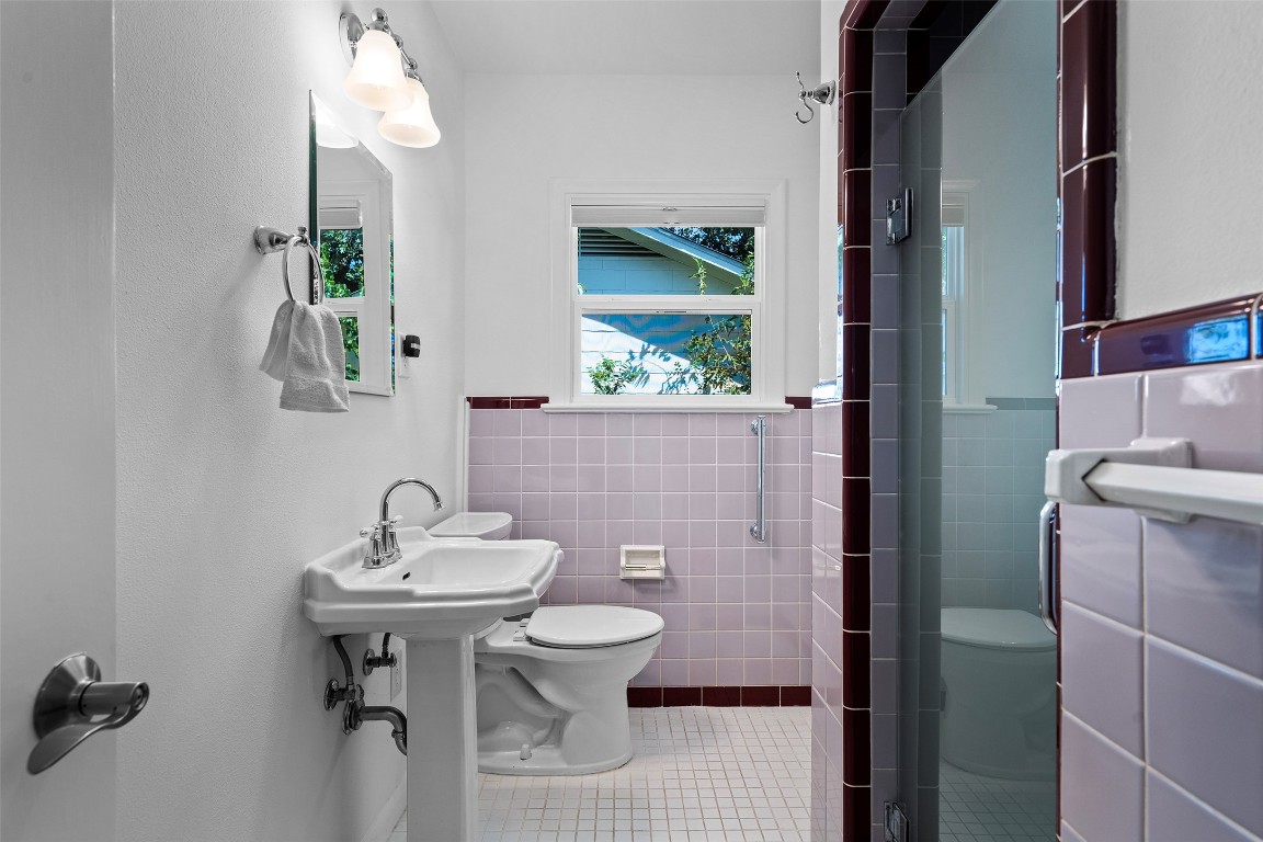 2606 Westover Road Austin, TX 78703 - Photo 29 of 38 a bathroom with a sink a toilet and mirror