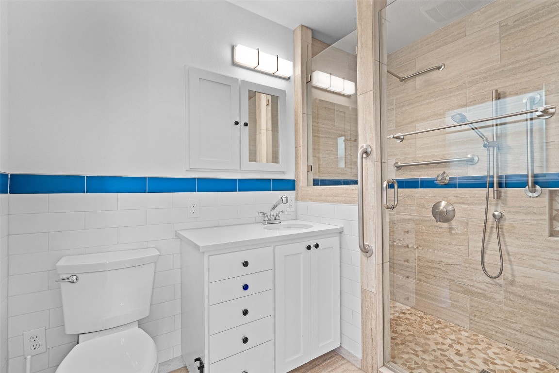 2606 Westover Road Austin, TX 78703 - Photo 30 of 38 a bathroom with a sink a toilet and shower