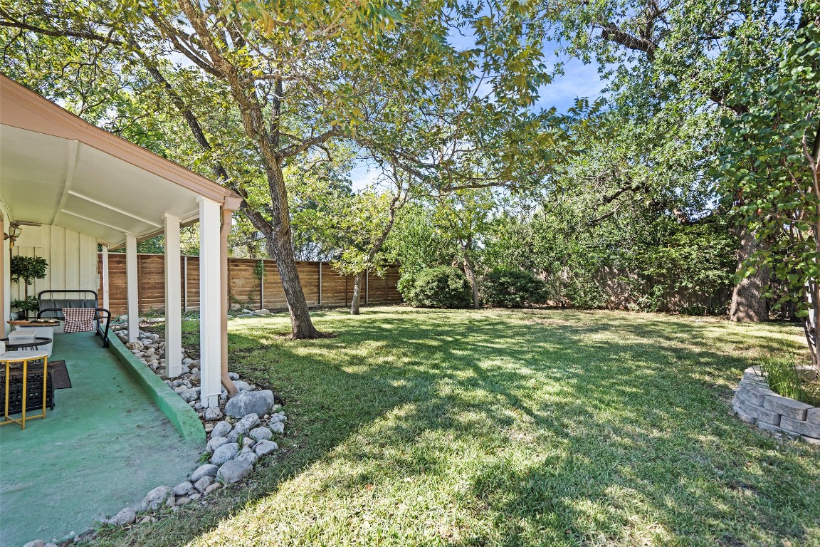 2606 Westover Road Austin, TX 78703 - Photo 34 of 38 a view of a backyard with table and chairs and a large tree