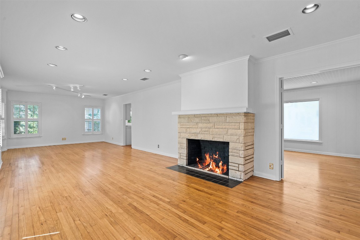 2606 Westover Road Austin, TX 78703 - Photo 5 of 38 a view of an empty room with wooden floor fireplace and a window