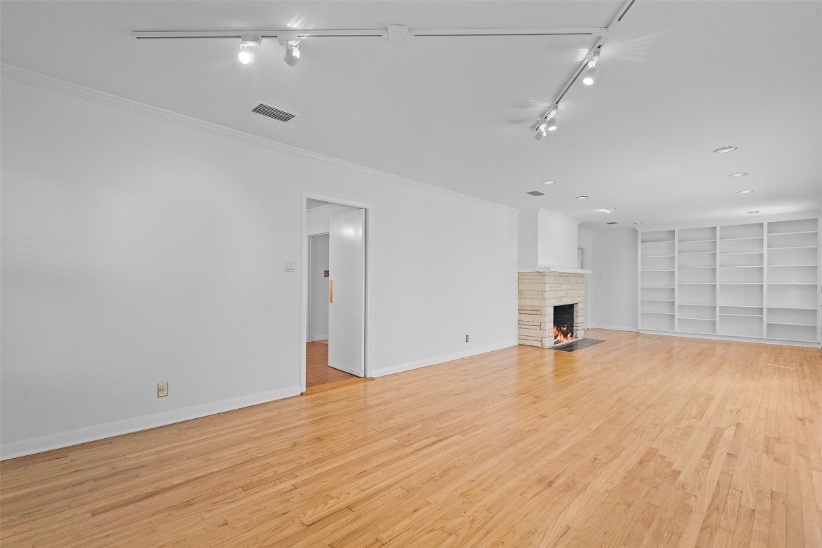 2606 Westover Road Austin, TX 78703 - Photo 6 of 38 wooden floor in an empty room with a kitchen