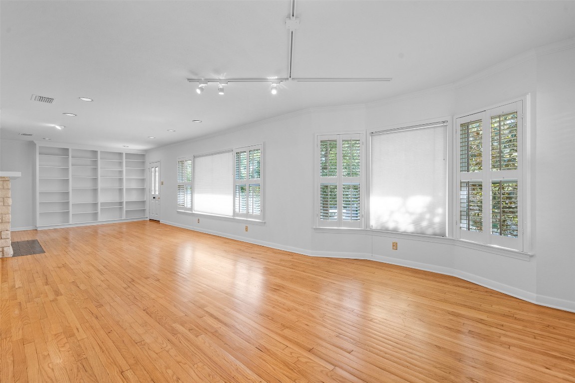 2606 Westover Road Austin, TX 78703 - Photo 7 of 38 an empty room with wooden floor and windows