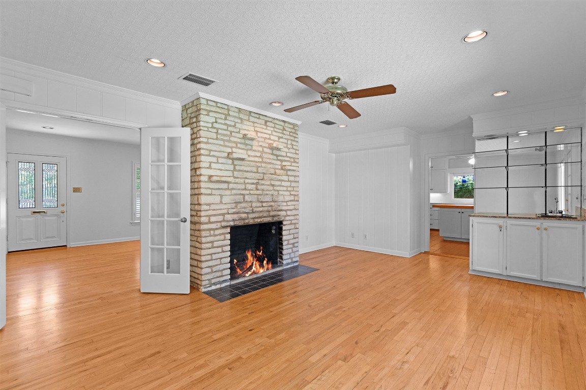 2606 Westover Road Austin, TX 78703 - Photo 8 of 38 a view of empty room with wooden floor and fireplace