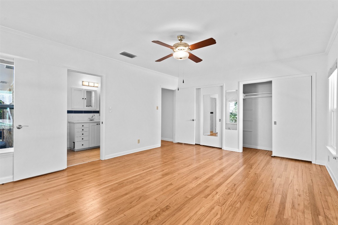 2606 Westover Road Austin, TX 78703 - Photo 9 of 38 a view of empty room with wooden floor and ceiling fan