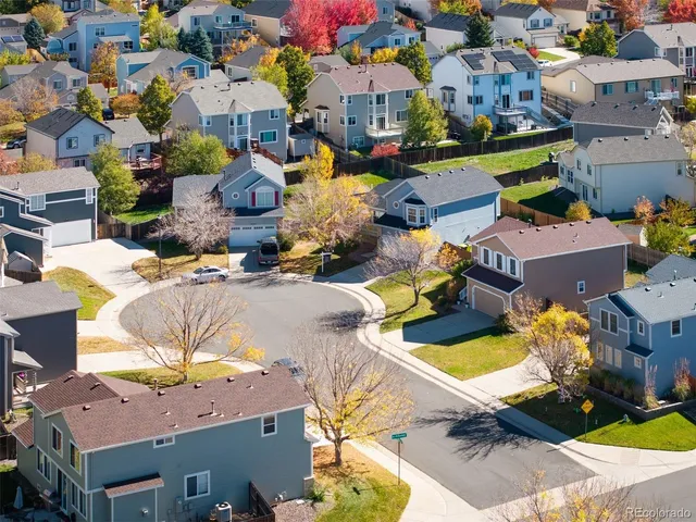 an aerial view of a houses with yard
