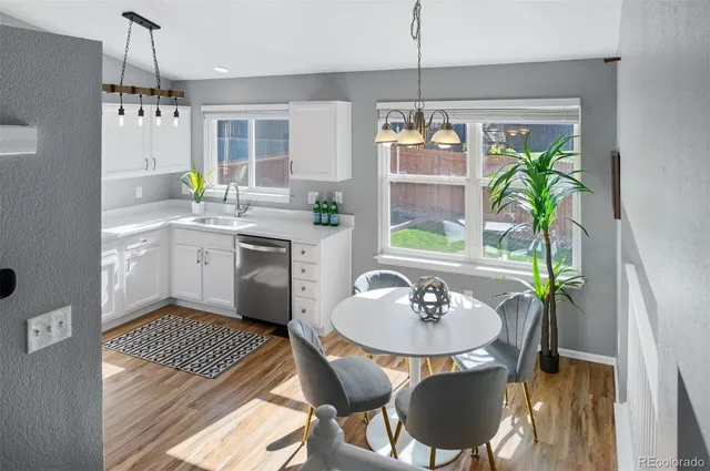a kitchen with a table chairs and a chandelier