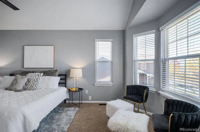 a bedroom with a bed and a couch