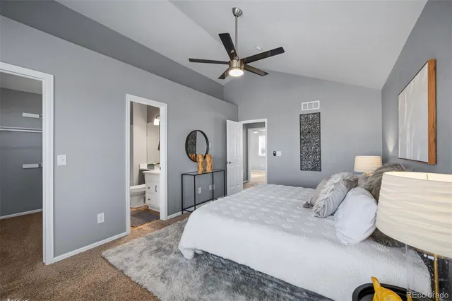 a bedroom with a bed and a large mirror