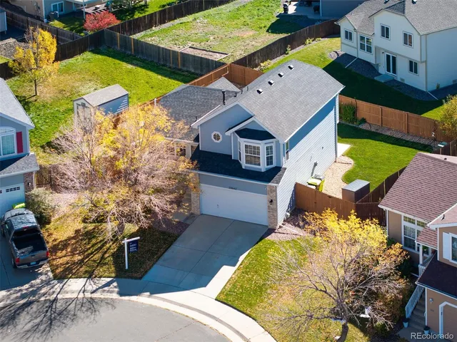 an aerial view of a house with yard swimming pool and outdoor seating