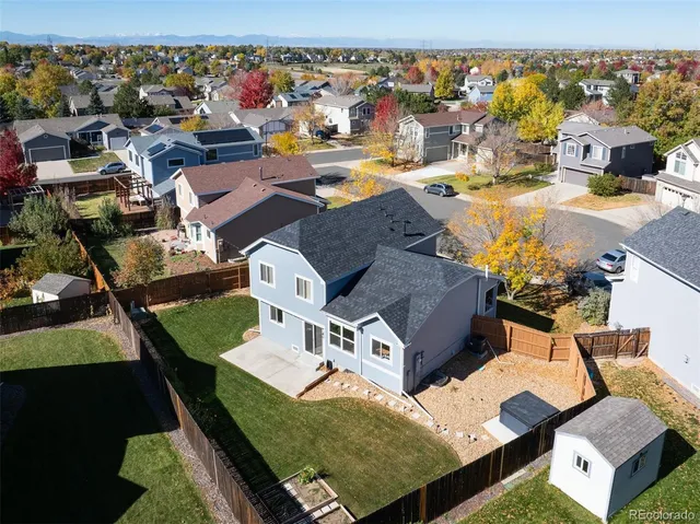 an aerial view of residential houses with outdoor space