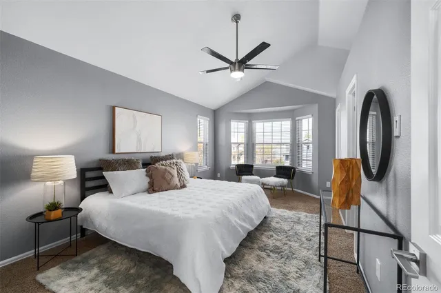 a bedroom with a bed a couch and dresser