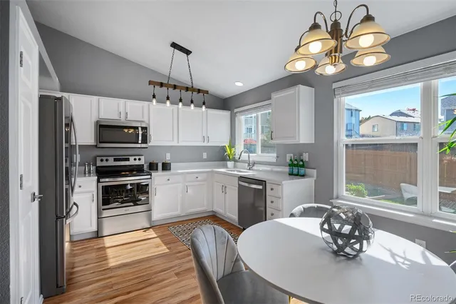 a kitchen with a center island a window appliances and cabinets
