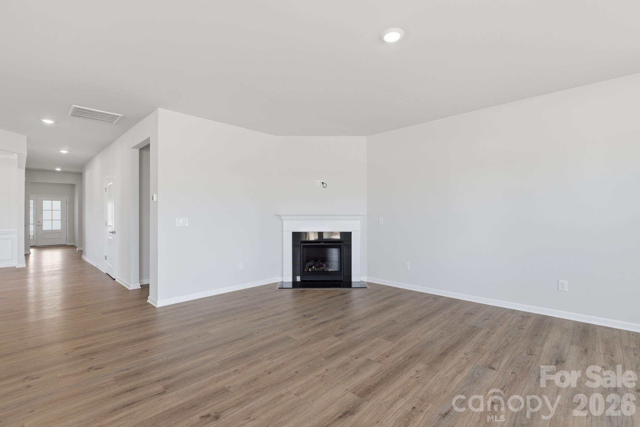 5475 Redbud Road, Unit 57 Lancaster, SC 29720 - Photo 8 of 30 a view of an empty room with wooden floor fireplace and a window