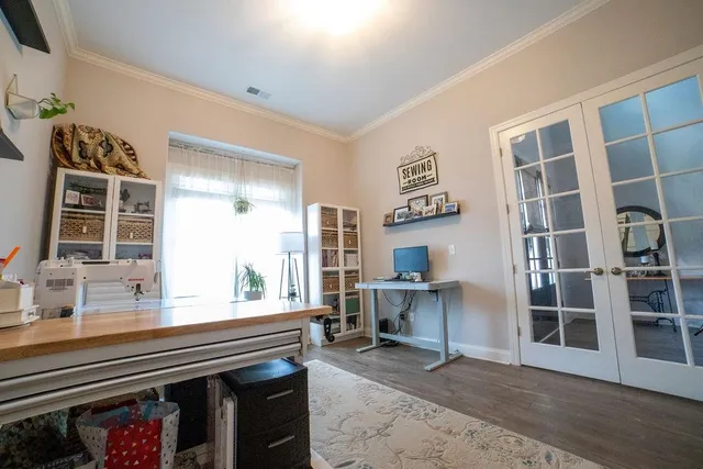 a living room with furniture a piano and a window