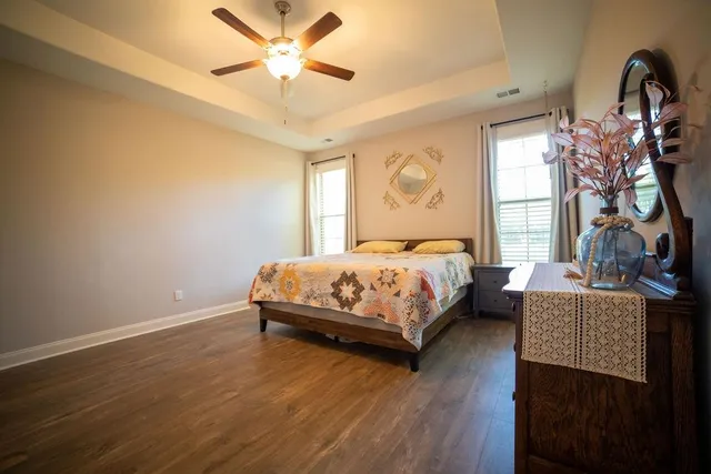 a bedroom with a bed and a chandelier