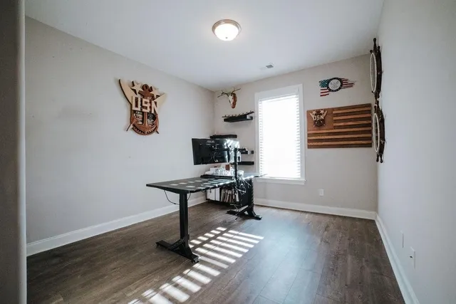 a view of a workspace with furniture and wooden floor