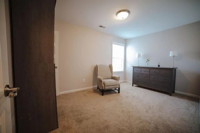 a living room with furniture and a chair