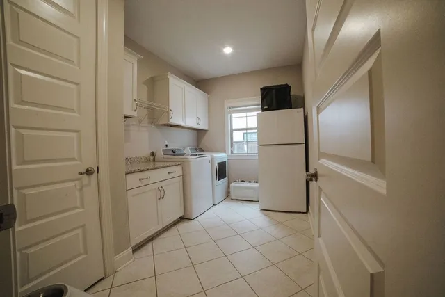 a kitchen with a refrigerator sink stove and cabinets