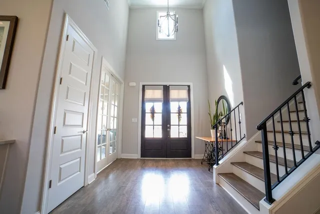 a view of an entryway with wooden floor and stairs