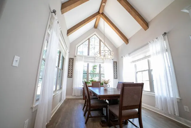 a view of a dining room with furniture and a large window