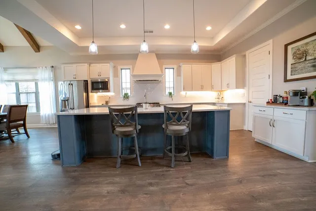 a kitchen with cabinets and chairs in it