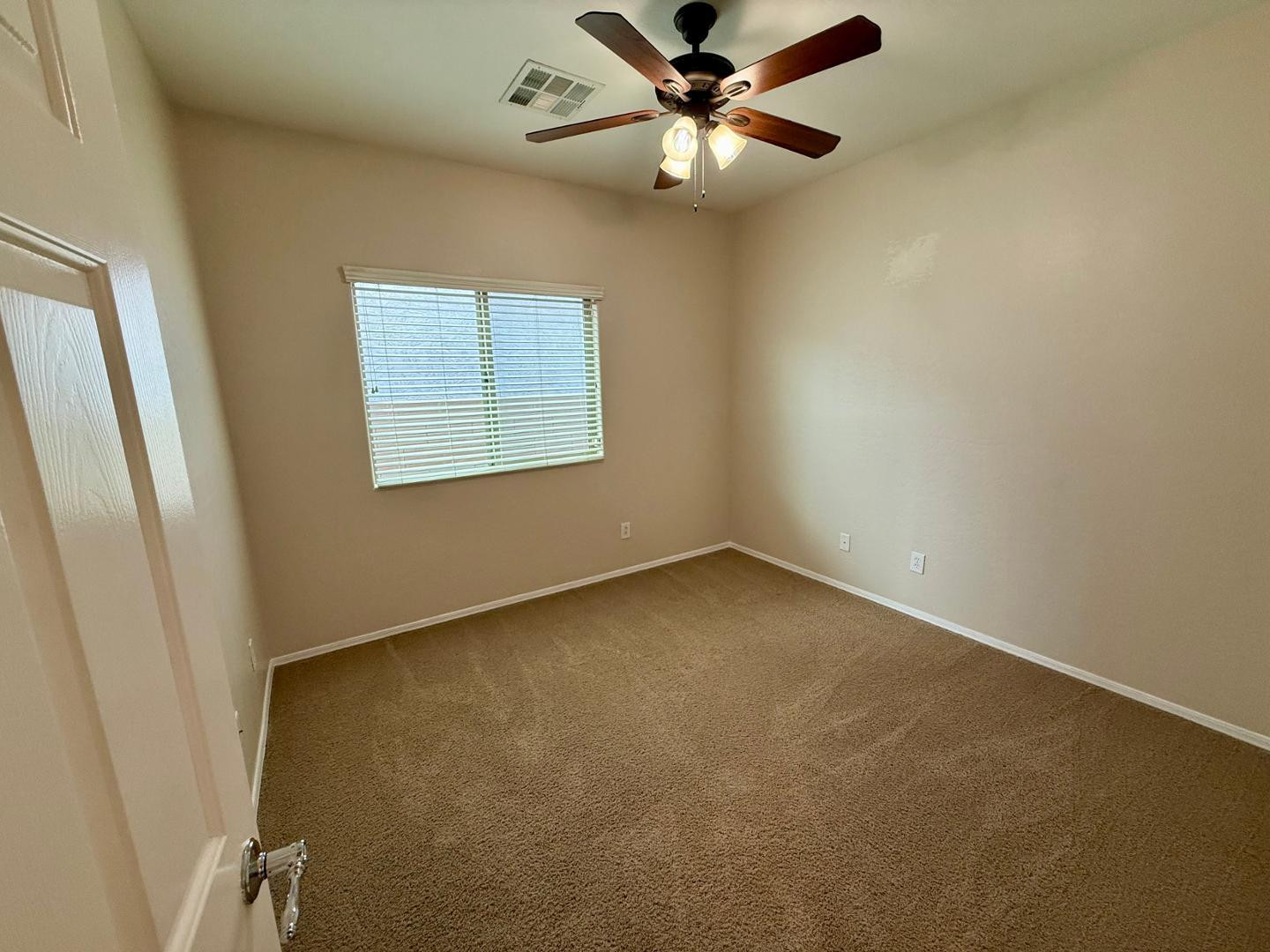 1929 West Black Hill Road Phoenix, AZ 85085 - Photo 17 of 26 an empty room with a window and a fan