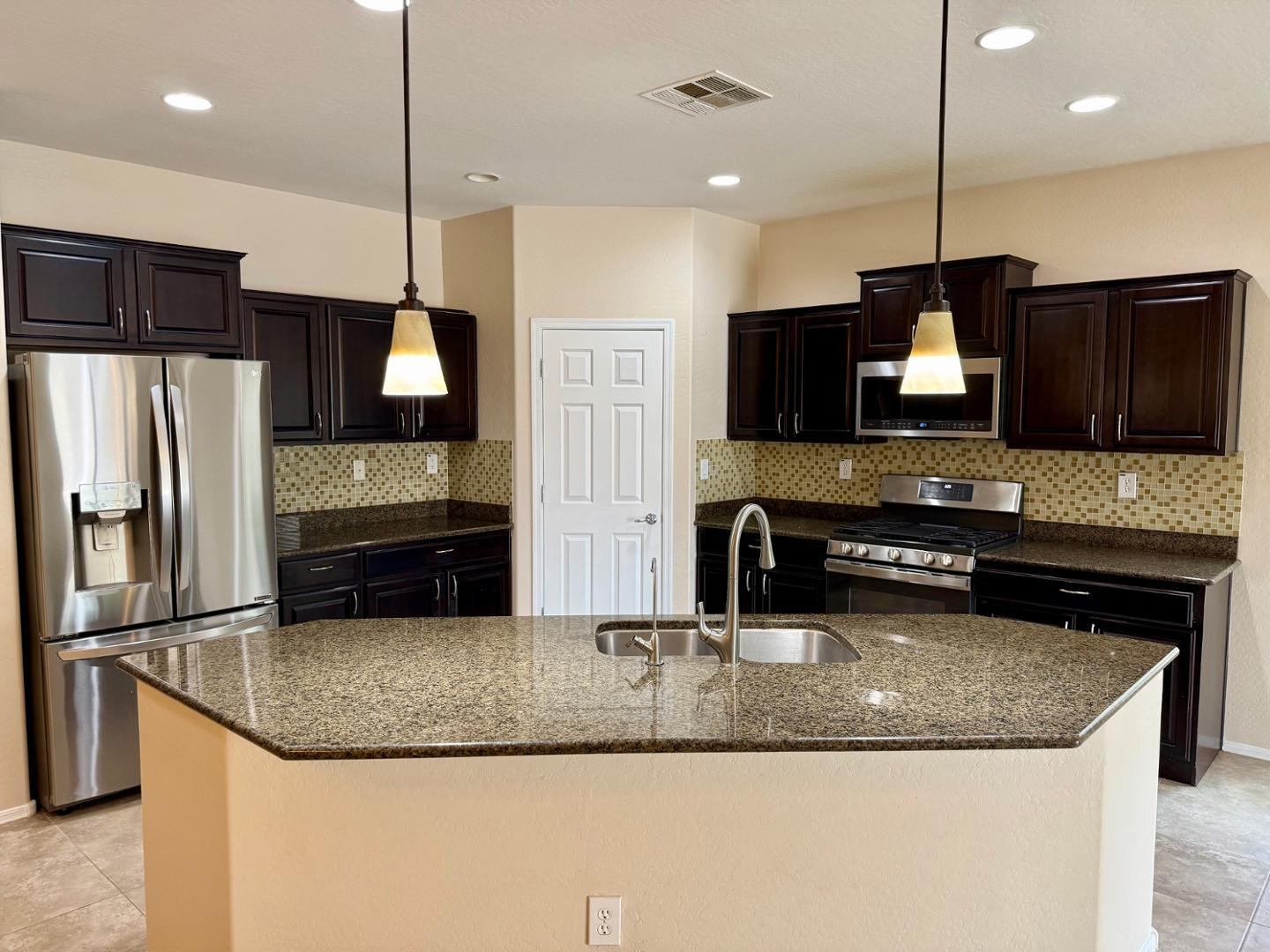 1929 West Black Hill Road Phoenix, AZ 85085 - Photo 8 of 26 a kitchen with stainless steel appliances granite countertop a sink refrigerator and microwave