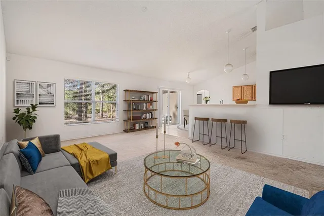 a kitchen with a dining table chairs and white cabinets