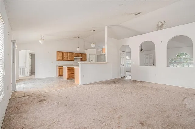 a kitchen with refrigerator cabinets and wooden floor