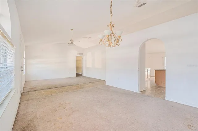 a large kitchen with a stove a sink a microwave and a refrigerator