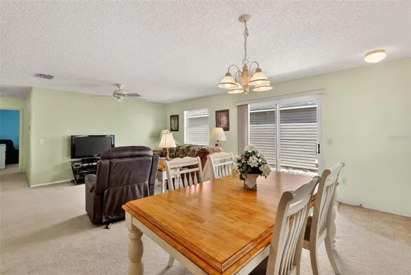 a dining room with furniture and window