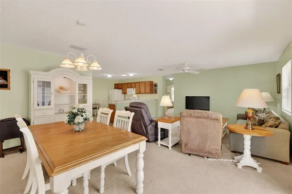 a view of a dining room with furniture and a chandelier
