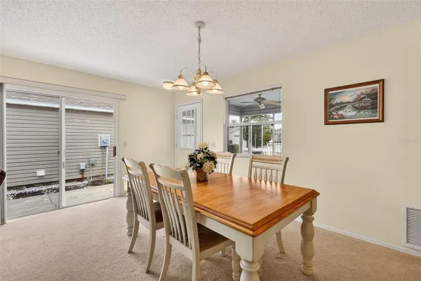 a view of a dining room with furniture and window