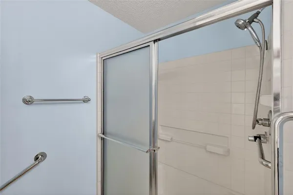 a bathroom with a glass shower door