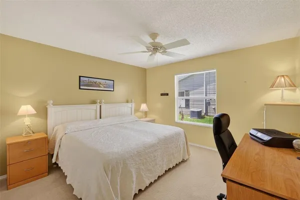 a bedroom with a bed and a chair