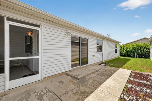 a view of backyard of house and garage