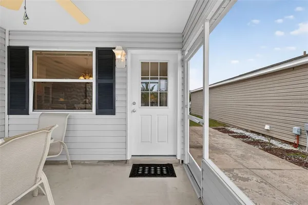 a view of a balcony with a door and wooden floor