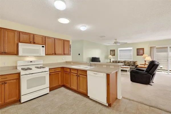 a kitchen with cabinets a sink and appliances